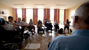 a group of disabled people in discussion in a function room