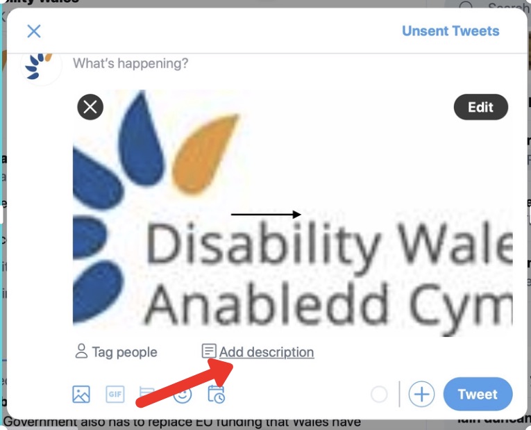 A screenshot of a tweet being composed. It shows a photo of the Disability Wales logo and there is a red arrow pointing to a button underneath that says 'Add Description.'