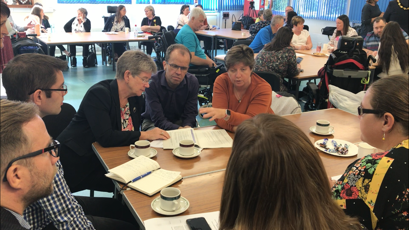 Photo of Jane Hutt speaking to disabled people in Bridgend