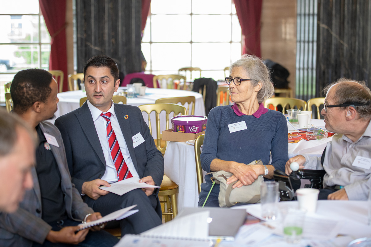 people discuss around a conference table